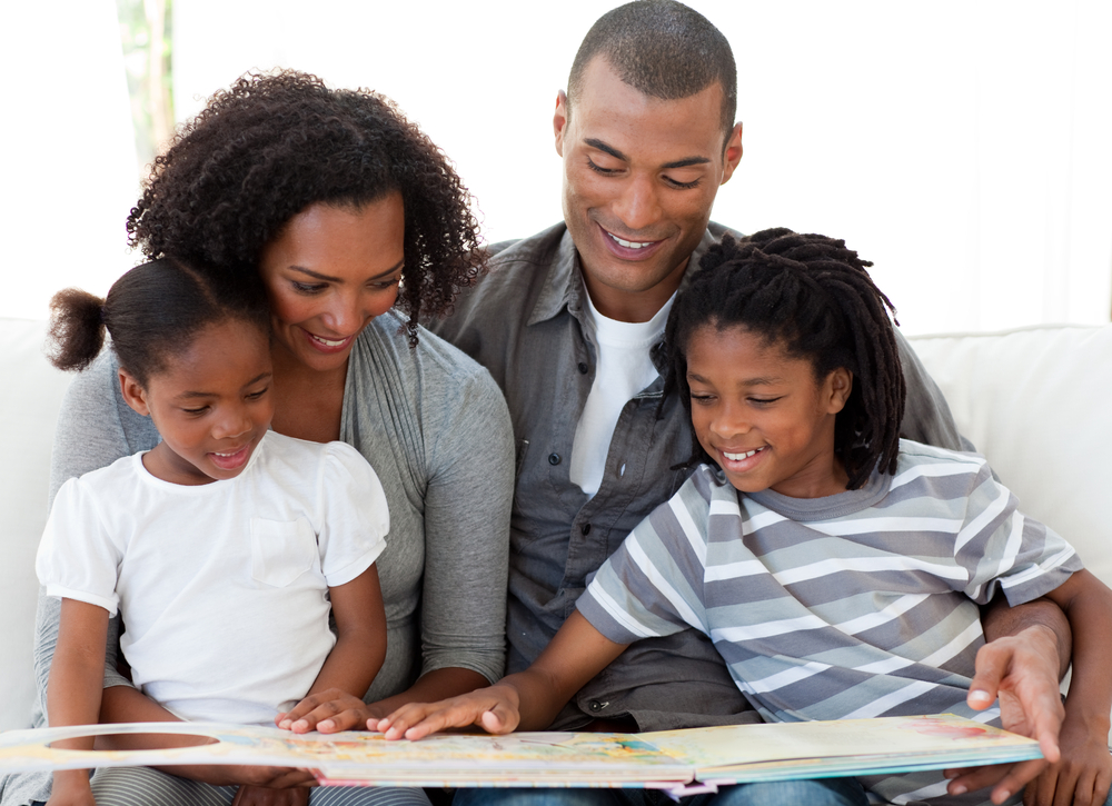 family reading together, father, mother, school aged children